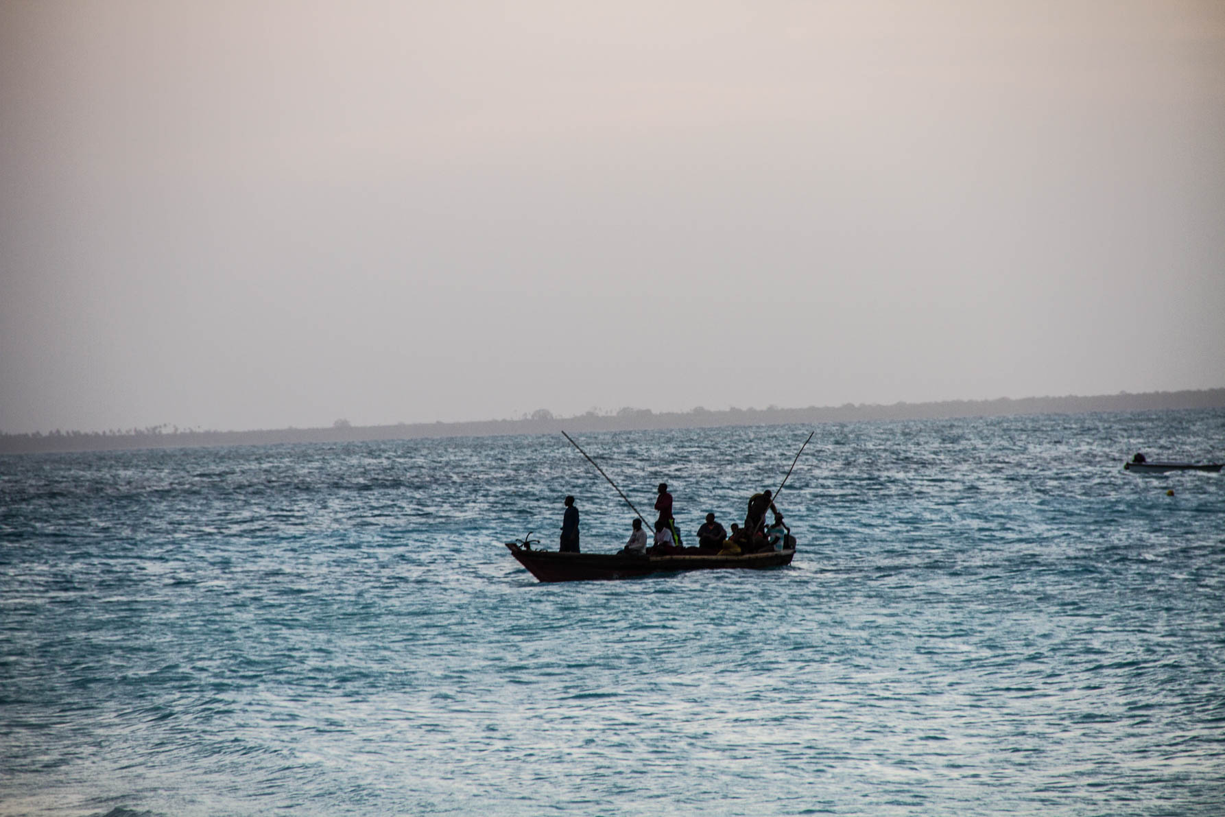 people fishing from a boat on the ocean